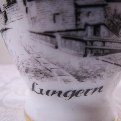 Small bud vase with cityscape on it