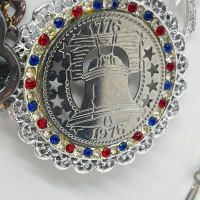 LOT 183J: Eclectic Silvertone Necklace Collection: Playboy Bunny, Rod Stewart, Liberty Bell and More