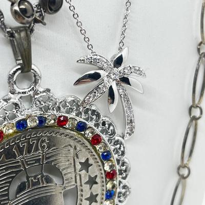 LOT 183J: Eclectic Silvertone Necklace Collection: Playboy Bunny, Rod Stewart, Liberty Bell and More