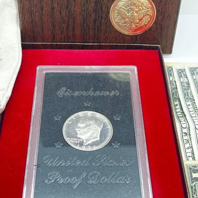 LOT 221J: US Currency Collection: 1957 $1 Silver Certificate, 1980 Susan B. Anthony Souvenir Set, 1997 Coin Set, Bag of Wheat Pennies