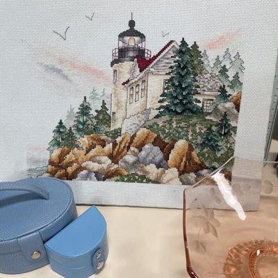 Pink depression, bowl, trinket boxes, teddy bear, bookends, and needlepoint picture of lighthouse