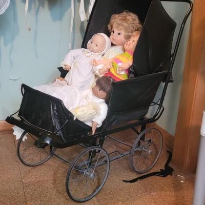 Sale Photo Thumbnail #106: Black doll buggy with assortment of dolls.