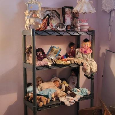 Sale Photo Thumbnail #228: Assortment of dolls, jewelry box with cherubs. Mary Kay case and artist signed mirror. Shelf excluded.