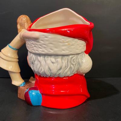 LOT:: 22 . Commemorative Christmas Ornaments, Royal Doulton Santa Head, Silvertone Dinner Bells and Scrooge and Tiny Tim figurine