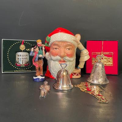 LOT:: 22 . Commemorative Christmas Ornaments, Royal Doulton Santa Head, Silvertone Dinner Bells and Scrooge and Tiny Tim figurine