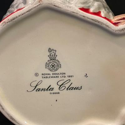 LOT:: 22 . Commemorative Christmas Ornaments, Royal Doulton Santa Head, Silvertone Dinner Bells and Scrooge and Tiny Tim figurine