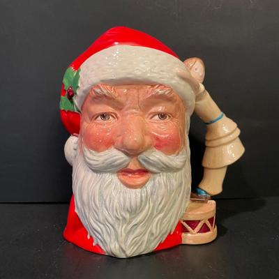 LOT:: 22 . Commemorative Christmas Ornaments, Royal Doulton Santa Head, Silvertone Dinner Bells and Scrooge and Tiny Tim figurine