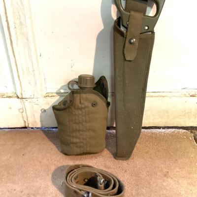 LOT 173: Military Collection - Olive Drab Duffle Bag, Ammo Storage Containers, Cantine Bottle, Saw, Shovel and More