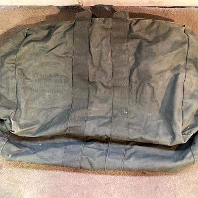LOT 173: Military Collection - Olive Drab Duffle Bag, Ammo Storage Containers, Cantine Bottle, Saw, Shovel and More