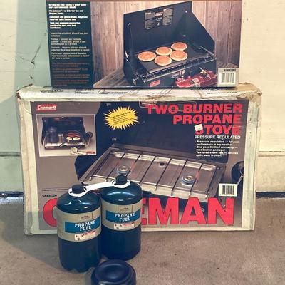 LOT 176: Coleman Collection in Original Packaging - Two Burner Portable Propane Stove, Cast Iron Griddle and Two Tanks