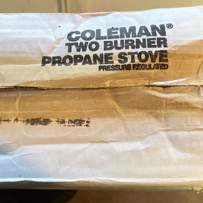 LOT 176: Coleman Collection in Original Packaging - Two Burner Portable Propane Stove, Cast Iron Griddle and Two Tanks