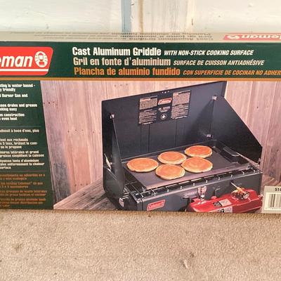 LOT 176: Coleman Collection in Original Packaging - Two Burner Portable Propane Stove, Cast Iron Griddle and Two Tanks