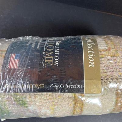 LOT 206: Large Assortment of Unopened Area Rugs In Various Sizes and Shapes.