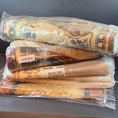 LOT 206: Large Assortment of Unopened Area Rugs In Various Sizes and Shapes.