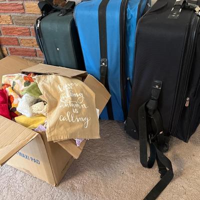 3 suitcases and a box of towels
