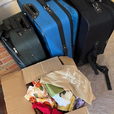 3 suitcases and a box of towels
