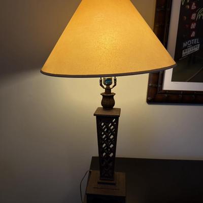 Sale Photo Thumbnail #32: The Herda Table Lamp is a mid-century style lighting fixture designed for the living room. It features a multicolor lattice design finish and is crafted from high-quality materials. The lamp stands 31 inches tall and includes a classic fabric shade. It us