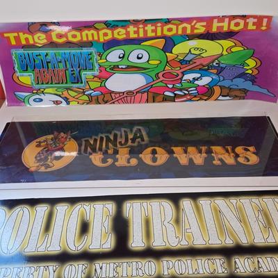 LOT 80B: Bust-A-Move Again Ex, Ninja Clowns, and Police Trainer Pinball Machine Marquees