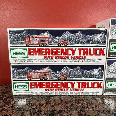 LOT 83C: Hess Trucks w/ Box - Sport Utility Vehicle w/ Motorcycles, Emergency Truck & More