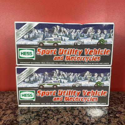 LOT 83C: Hess Trucks w/ Box - Sport Utility Vehicle w/ Motorcycles, Emergency Truck & More