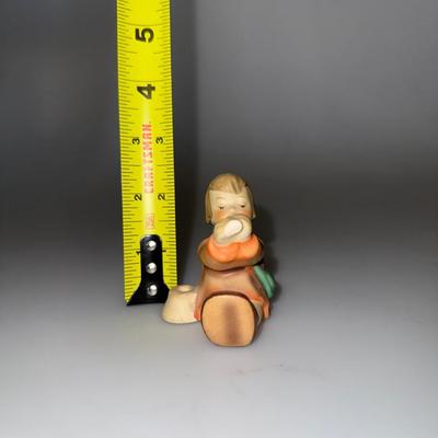 The Goebel Hummel "Angel Sitting Playing Horn" figurine See Blimish