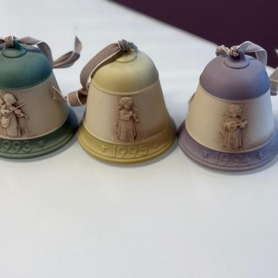 This lot of three M.J. Hummel Christmas bell ornaments
