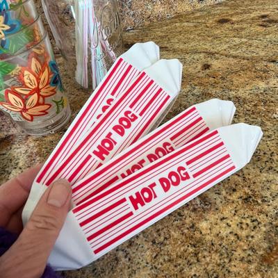 Lot 107 popcorn buckets, hot dog trays, football plates and napkins