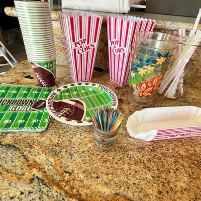 Lot 107 popcorn buckets, hot dog trays, football plates and napkins