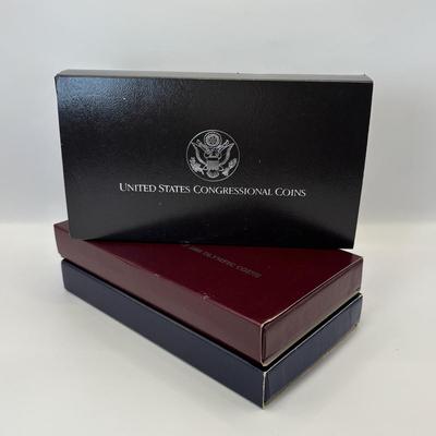 LOT 246: Unites States Constitution 1987 Silver Dollar, United States Olympic Coin 1988 Proof Silver Dollar, United States Proclaining...