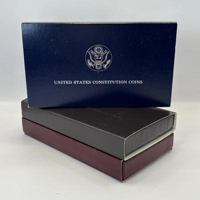 LOT 246: Unites States Constitution 1987 Silver Dollar, United States Olympic Coin 1988 Proof Silver Dollar, United States Proclaining...