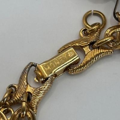 LOT 313: Monet Charm Bracelet with 8 Charms. Chain is 7.5" and has Safety Chain & More