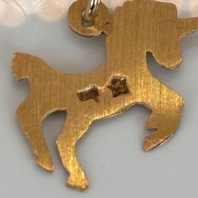 LOT 313: Monet Charm Bracelet with 8 Charms. Chain is 7.5" and has Safety Chain & More