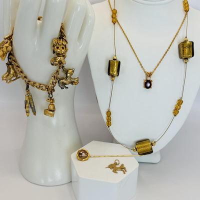 LOT 313: Monet Charm Bracelet with 8 Charms. Chain is 7.5" and has Safety Chain & More