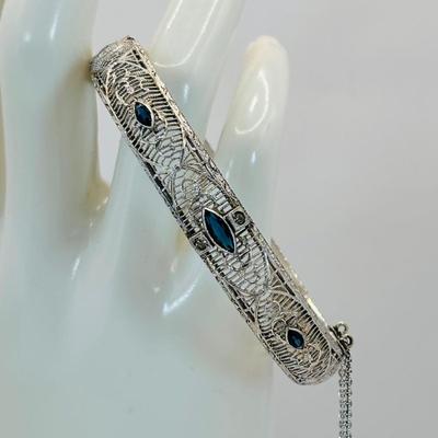 LOT 318: Art Deco Chromium Plated Filagree Hinged Bangle Bracelet w/ Saftey Chain and Blue Paste (Glass) and Clear Rhinestones Marked JHP...