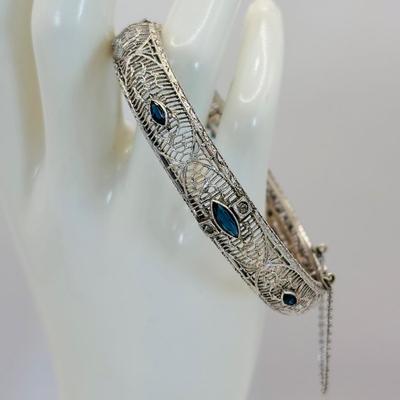 LOT 318: Art Deco Chromium Plated Filagree Hinged Bangle Bracelet w/ Saftey Chain and Blue Paste (Glass) and Clear Rhinestones Marked JHP...