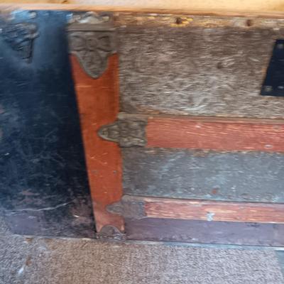 ANTIQUE TRUNK WITH DECORATIVE TIN AND LEATHER STRAPS