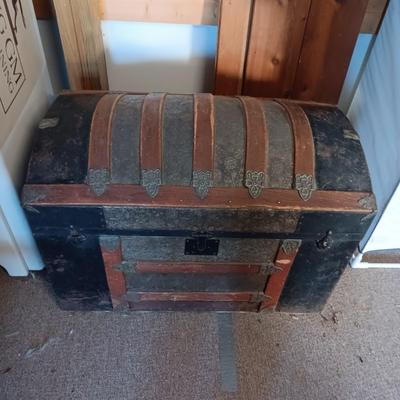 ANTIQUE TRUNK WITH DECORATIVE TIN AND LEATHER STRAPS