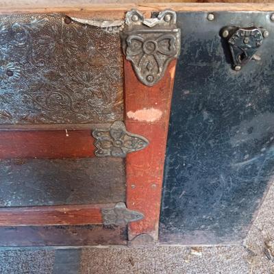 ANTIQUE TRUNK WITH DECORATIVE TIN AND LEATHER STRAPS