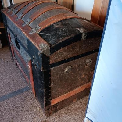 ANTIQUE TRUNK WITH DECORATIVE TIN AND LEATHER STRAPS
