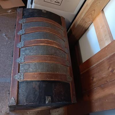 ANTIQUE TRUNK WITH DECORATIVE TIN AND LEATHER STRAPS