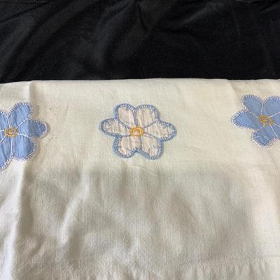 Lot of embroidered pillowcases, including one with floral appliqué
