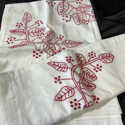 Lot of embroidered pillowcases, including one with floral appliqué