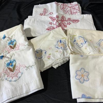 Lot of embroidered pillowcases, including one with floral appliqué