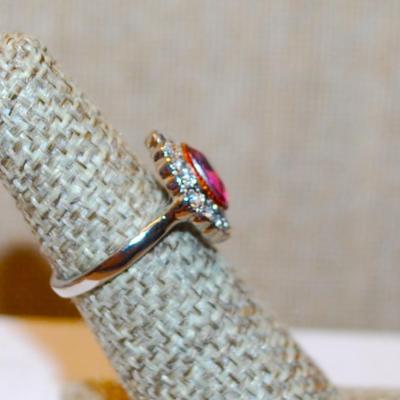 Size 5 Oval Translucent Red Stone Ring with Full Surround on a Silver Tone Band (3.4g)