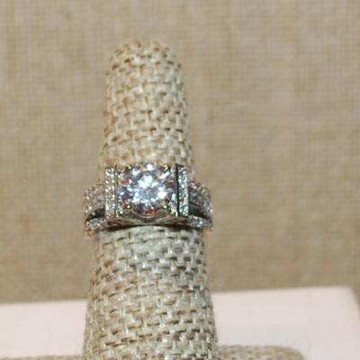 Size 6 Marked .925 Round Clear Main Stone Ring with Side Panels & Triple Stone Lines on a Silver Band (5.1g)