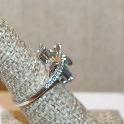 Size 7 Long Iridescent Rectangle Stone Party Ring with Fancy Wrap-Around Setting on a Silver Tone Band (4.4g)