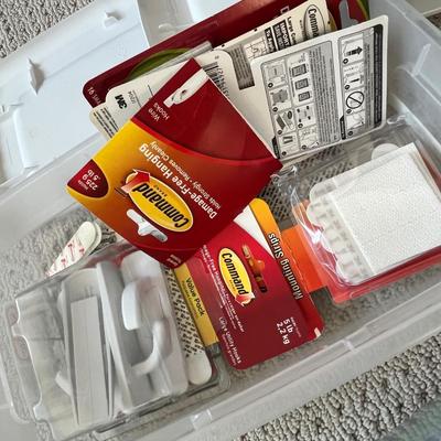Lot 184 3 plastic storage bins of office supplies - pens, binder clips, command strips