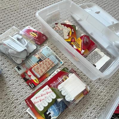 Lot 184 3 plastic storage bins of office supplies - pens, binder clips, command strips