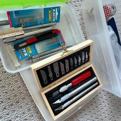 Lot 185 3 plastic bins of labels, glue and sticker labels and numerous exacto knives