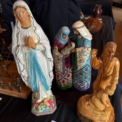 3 religious figures of various sizes